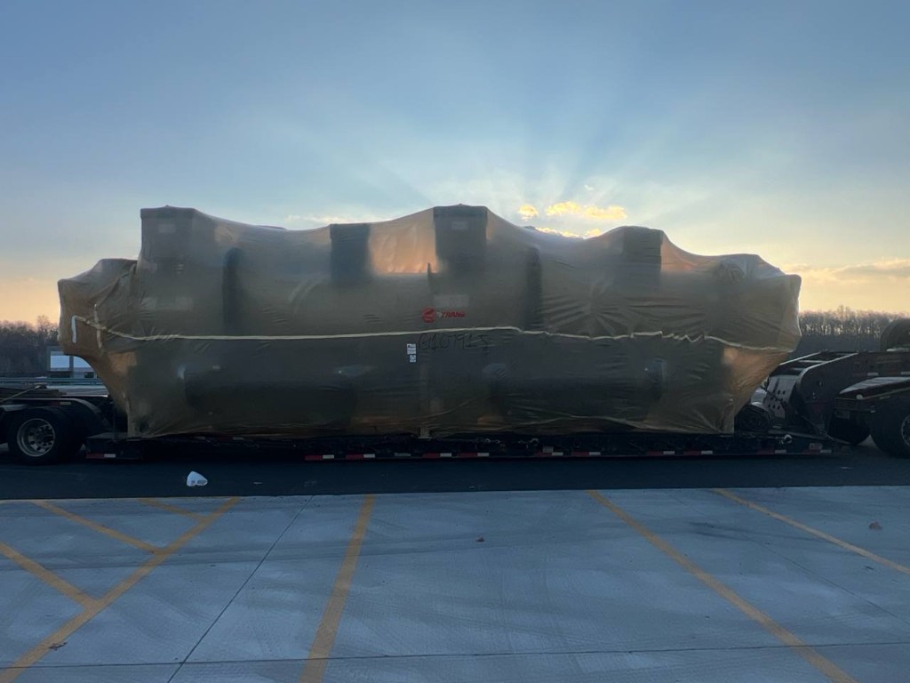 Tarped oversized load at sunrise