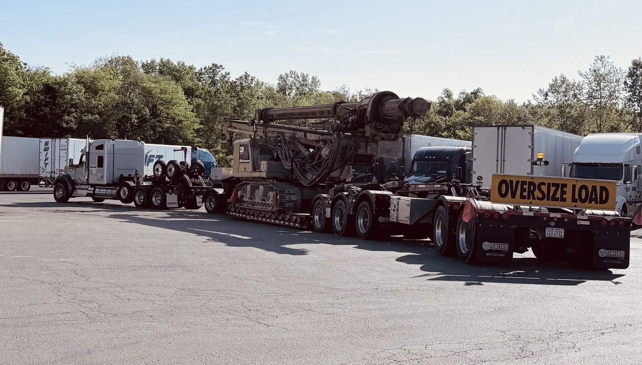 Drill rig on RGN with OVERSIZE LOAD plate